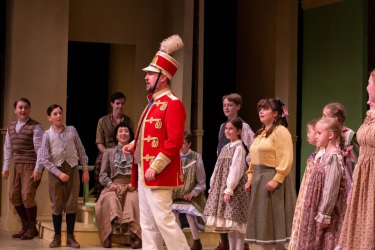 The Cast of The Music Man (2022). Directed and Choreographed by Stephanie Graham; Music Direction by Rachel Cameron; Assistant Choreographed by Keleshaye Christmas-Simpson; Set Design by Brandon Kleiman; Costume Design by Robin Fisher & Joshua Quinlan; Lighting Design by Renee Brode; Sound Design by Deanna Choi; Stage Managed by Jordan Guetter; Assistant Stage Managed by Cristina Hernadez; Apprentice Stage Managed by Arielle Voght. Photo by Randy deKleine-Stimpson.